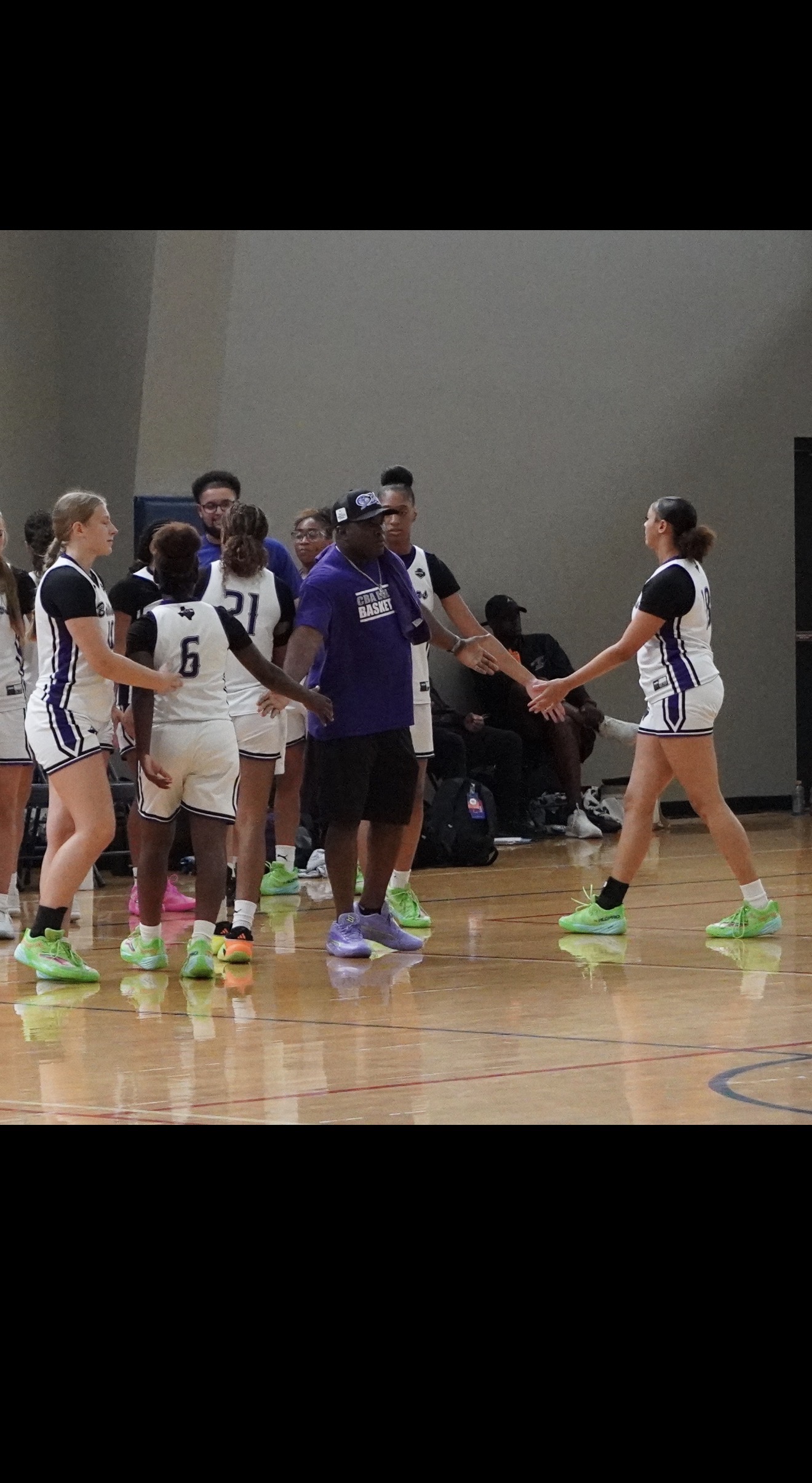 Ballers Ignited coaches teaching players in a huddle