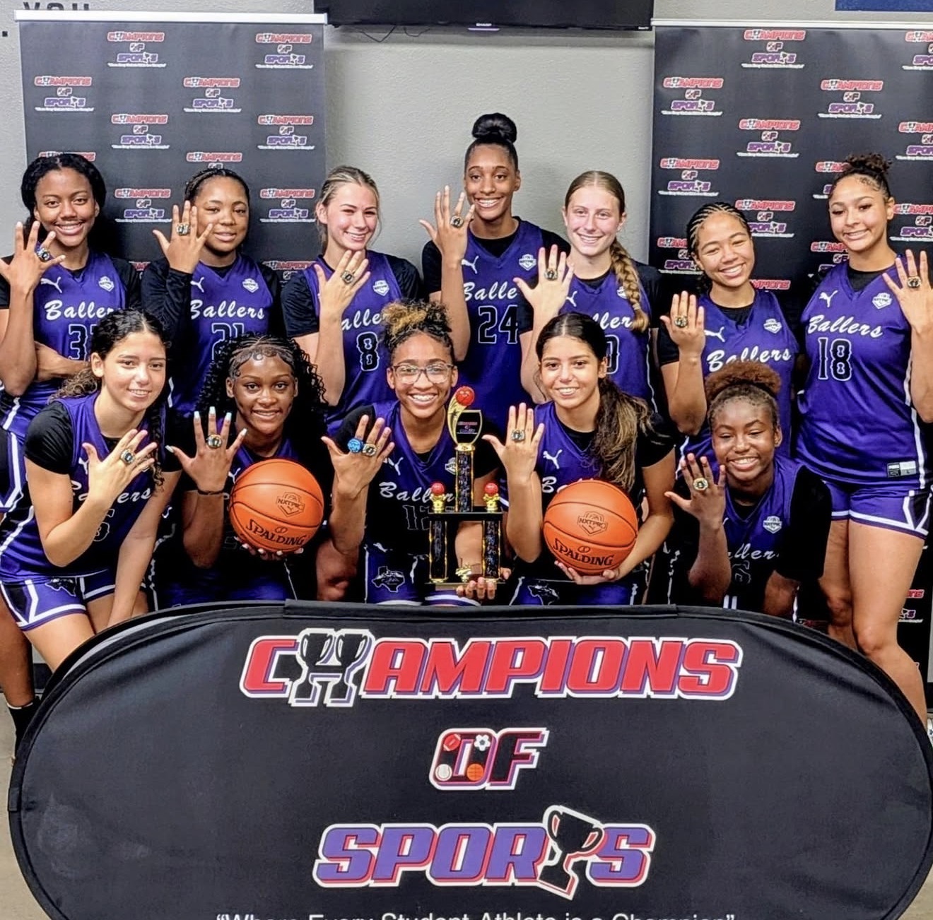 Ballers Ignited athletes celebrating together with a championship trophy