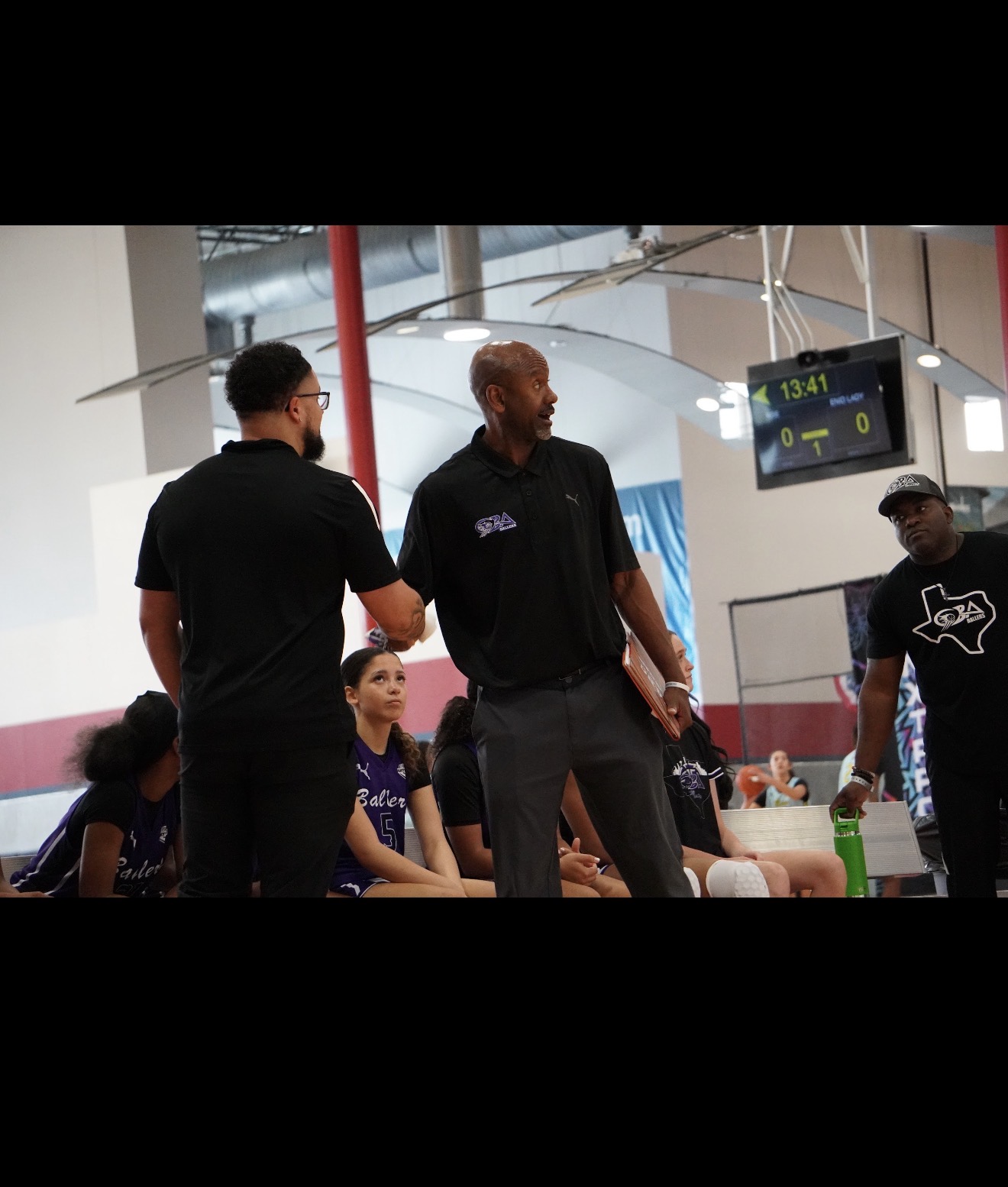 Coach Nervis talking to Coach Jordan